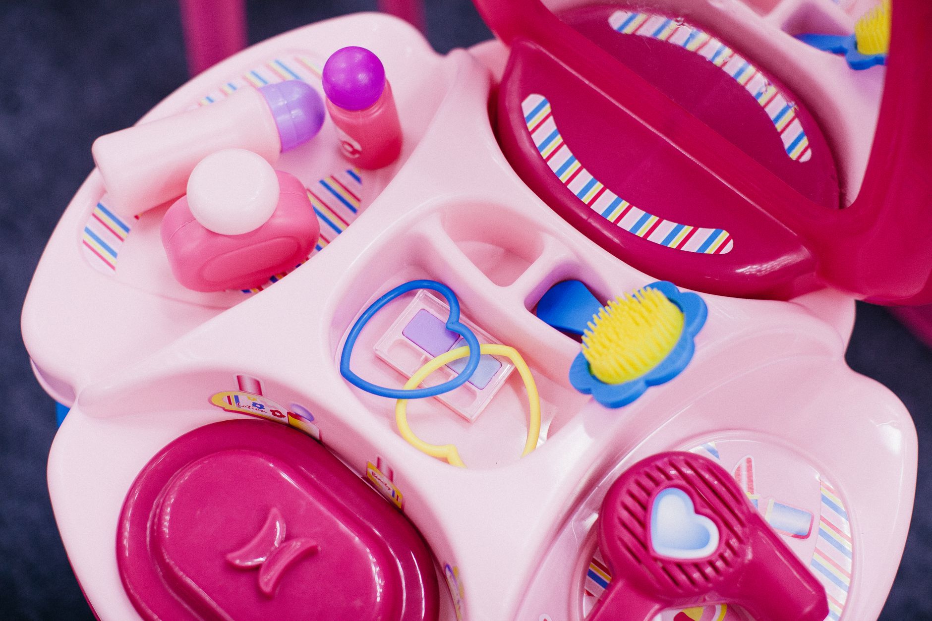 Bright children's vanity table with toy cosmetics and accessories. Perfect for imaginative play.