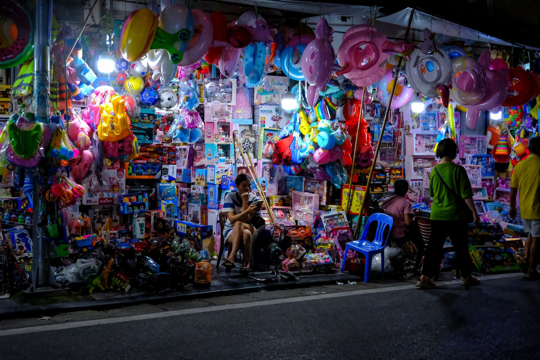 Vibrant toy stall at a night market showcasing colorful toys and decorations.