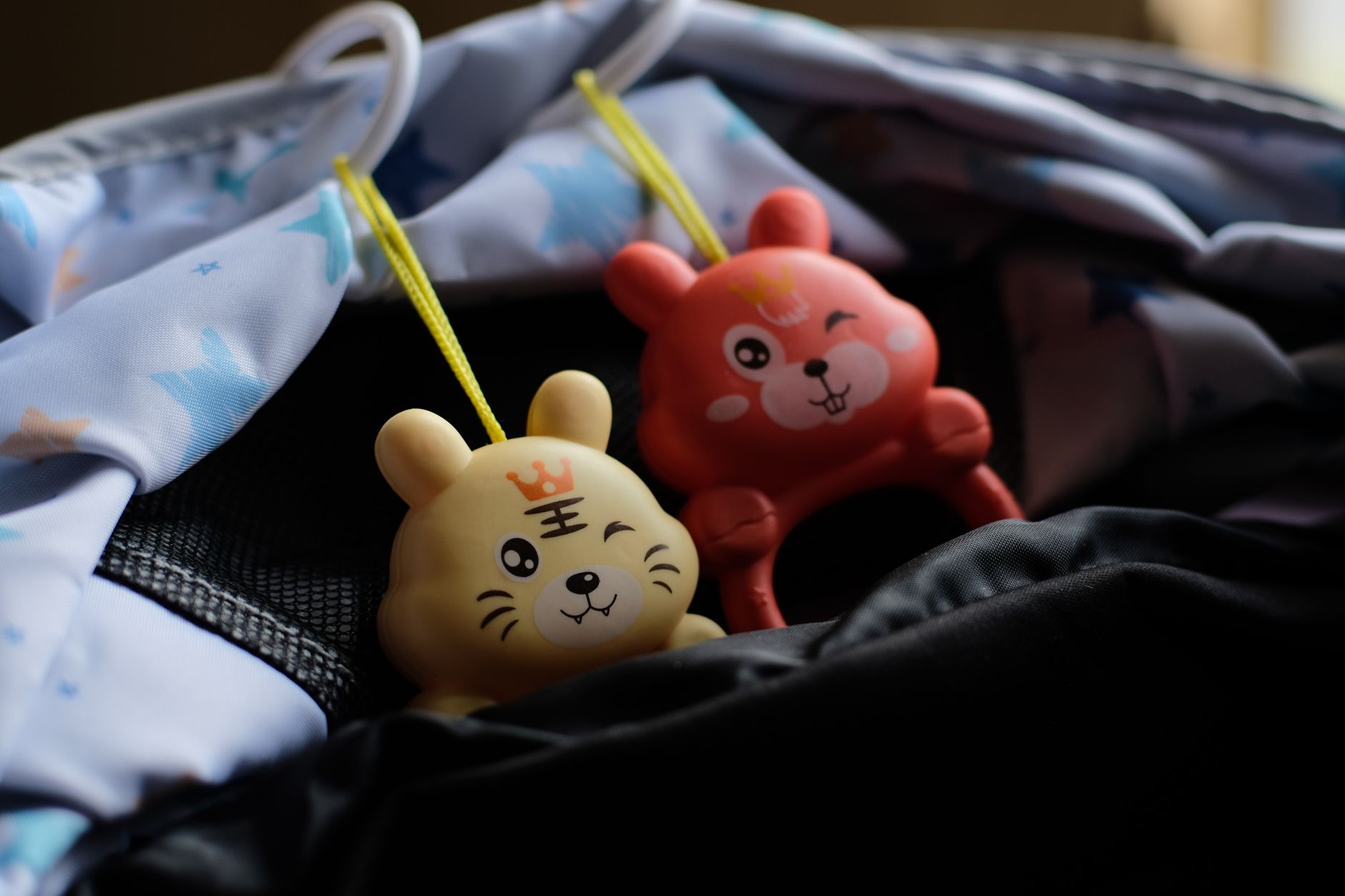 Charming animal character toys hang on baby carriage, adding a touch of fun and cuteness.